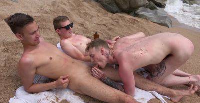 Naked lads share the beach for intimate gay sex in a perfect trio - alphaporno.com